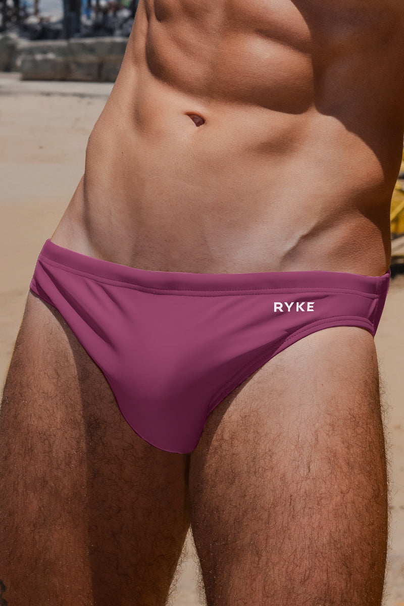 Close up of mens swim briefs in a rose colour